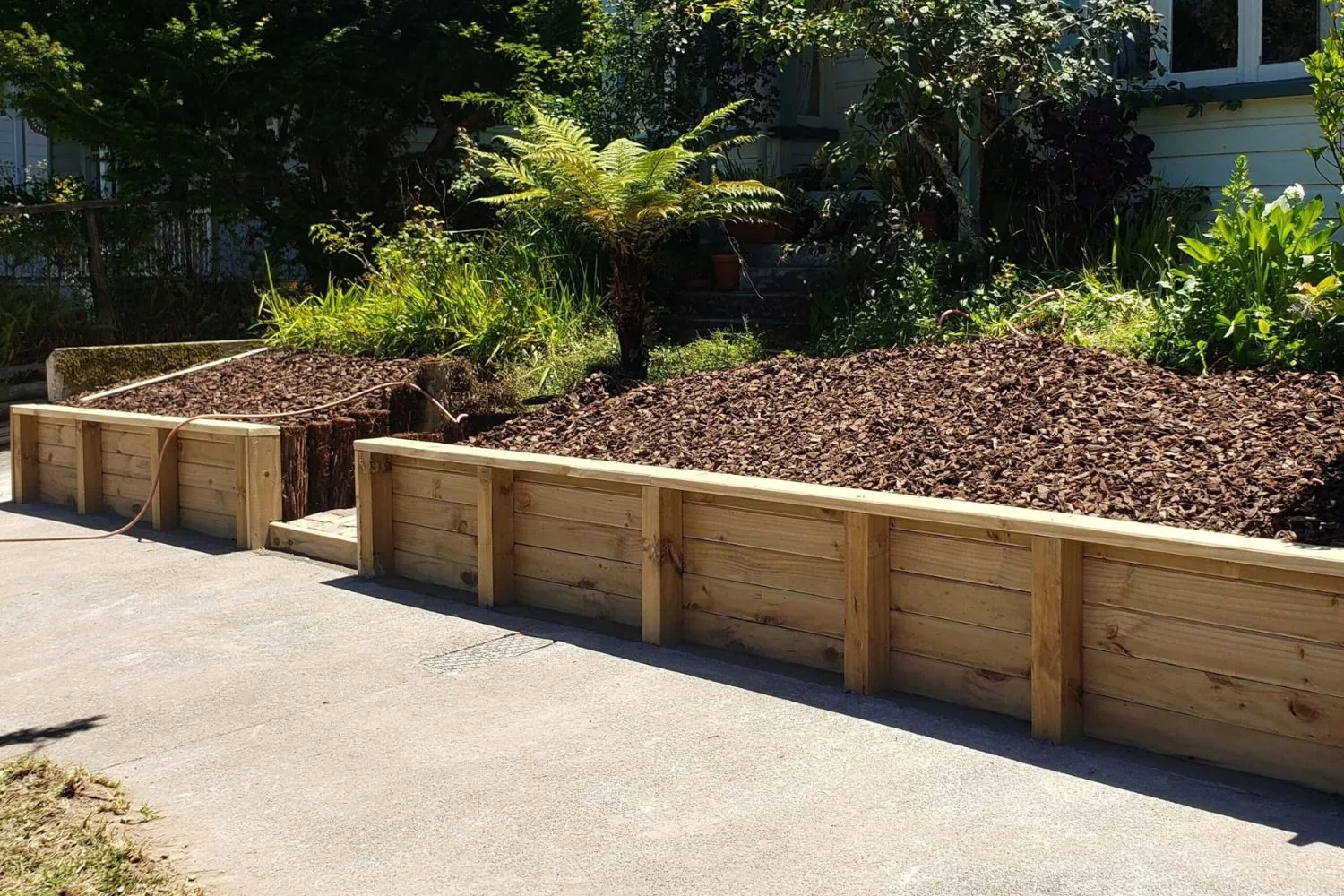 Treated timber retaining wall in a garden setting